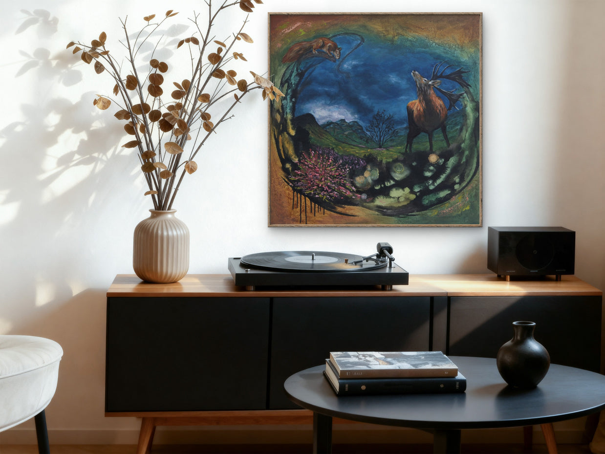 A sitting room featuring a painting of a stag with the backdrop of a Scottish landscape.