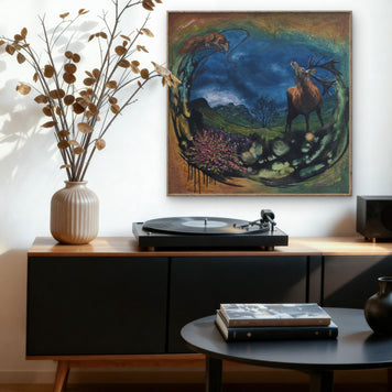 A sitting room featuring a painting of a stag with the backdrop of a Scottish landscape.