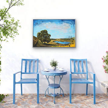 Balcony with blue chairs and table and a landscape painting.