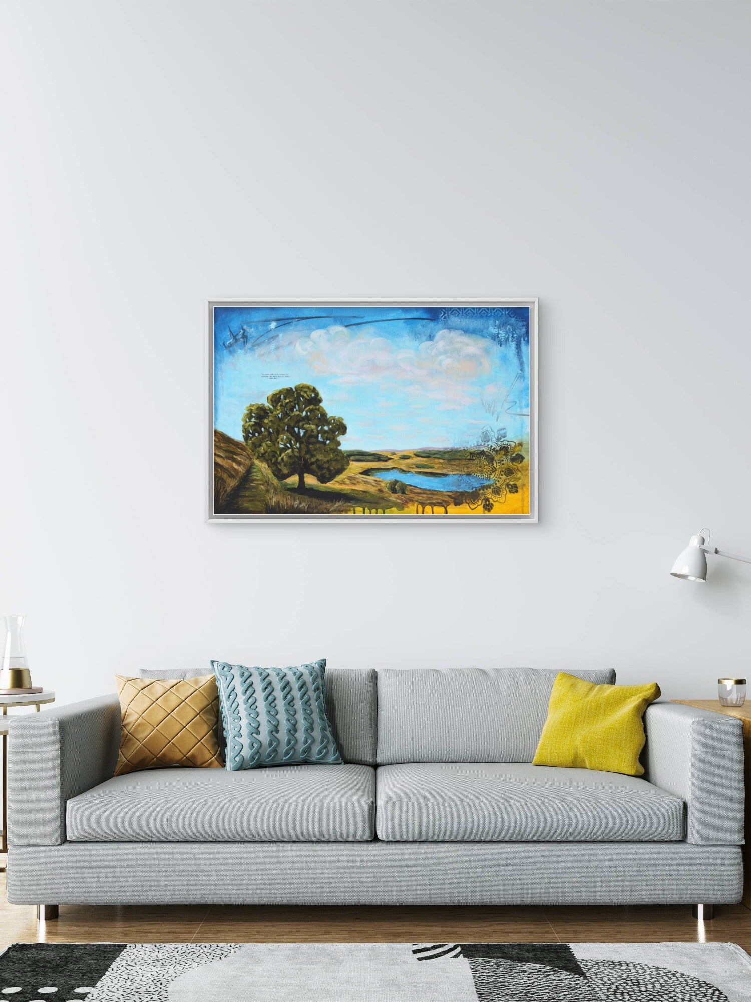 living room with a grey sofa and landscape painting.