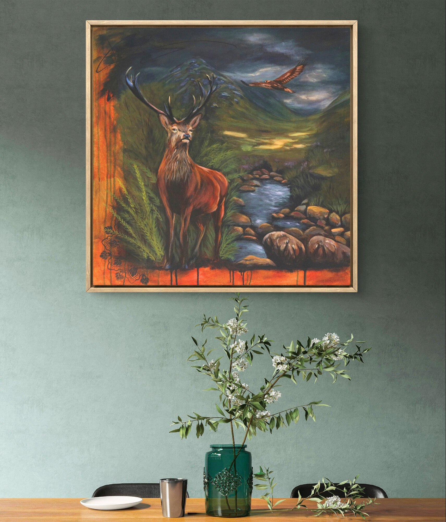 Grey wall featuring framed painting of the stag and the bird of prey.