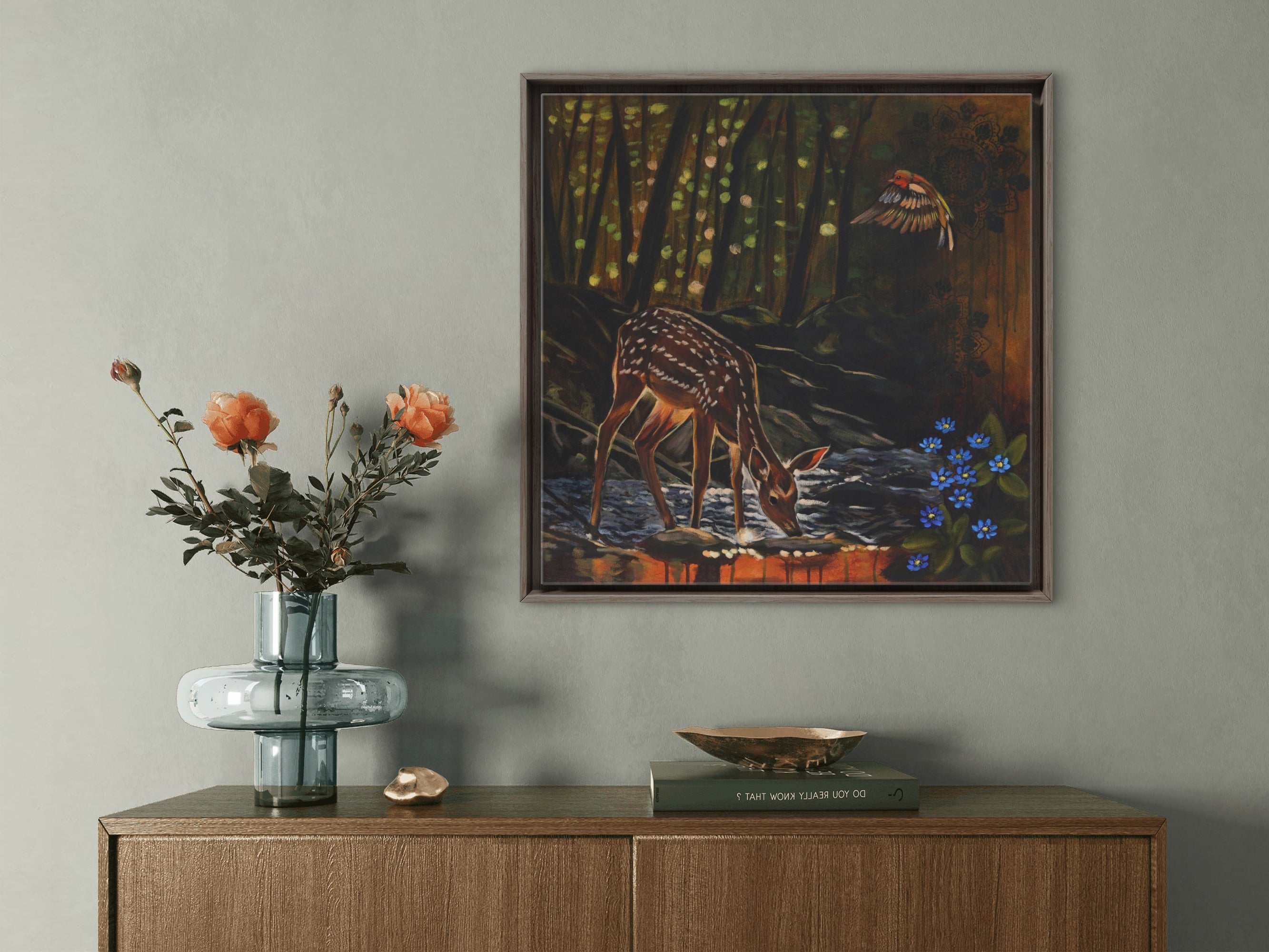 hallway side cupboard with flowers and painting of foe deer in the woods.