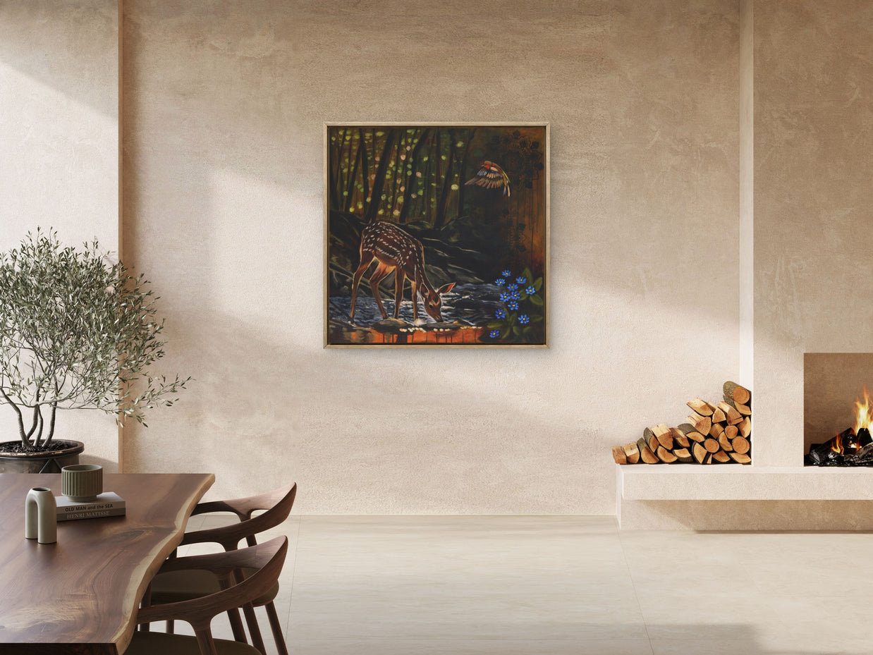 Modern open plan living space featuring foe deer painting near fire place.