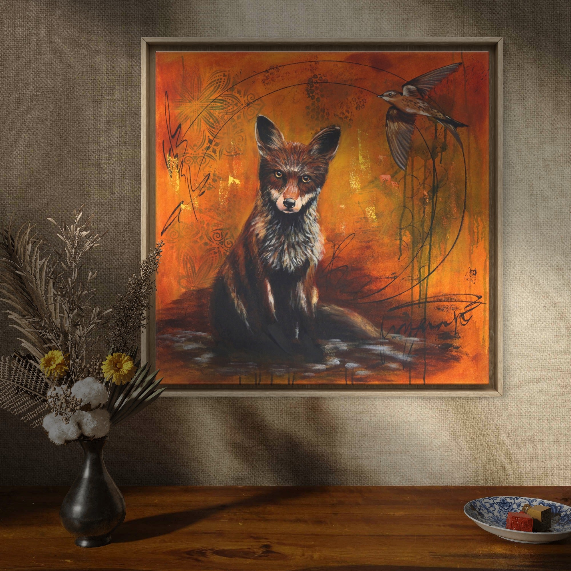 Framed painting of a fox on a natural looking wall.