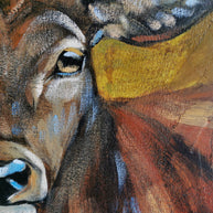 Close-up of a deer's face painted in brown and blue tones.