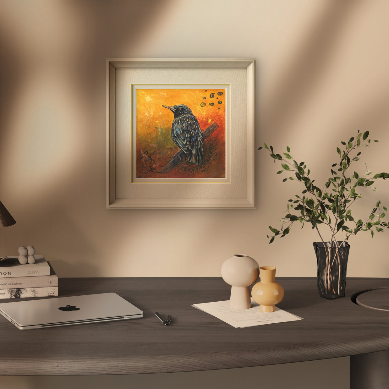 Small cozy office space featuring a painting of a starling.