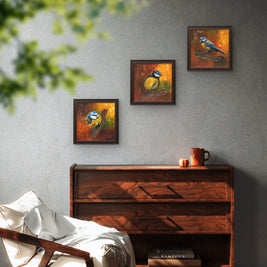 A room with chest of drawers and arrangement of 3 blue tit paintings.