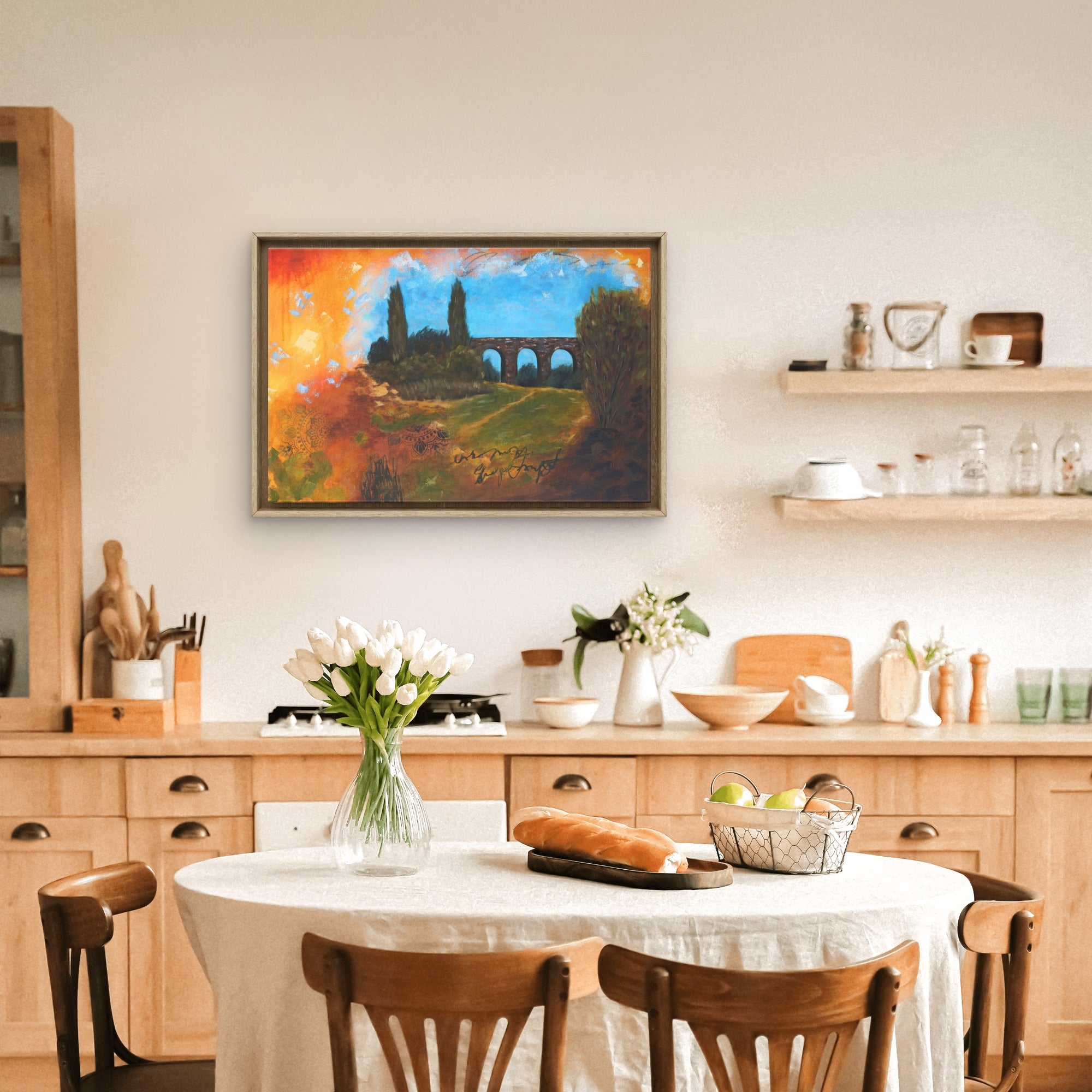 A bright dining room featuring abstract painting of of a viaduct.
