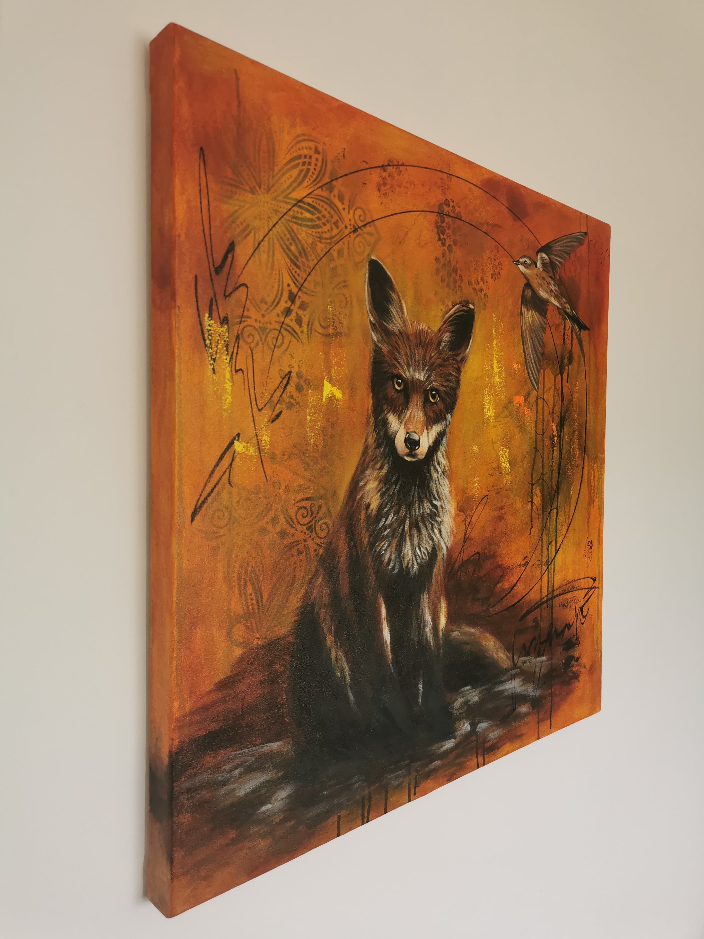 Side view of a painting featuring a fox and a bird