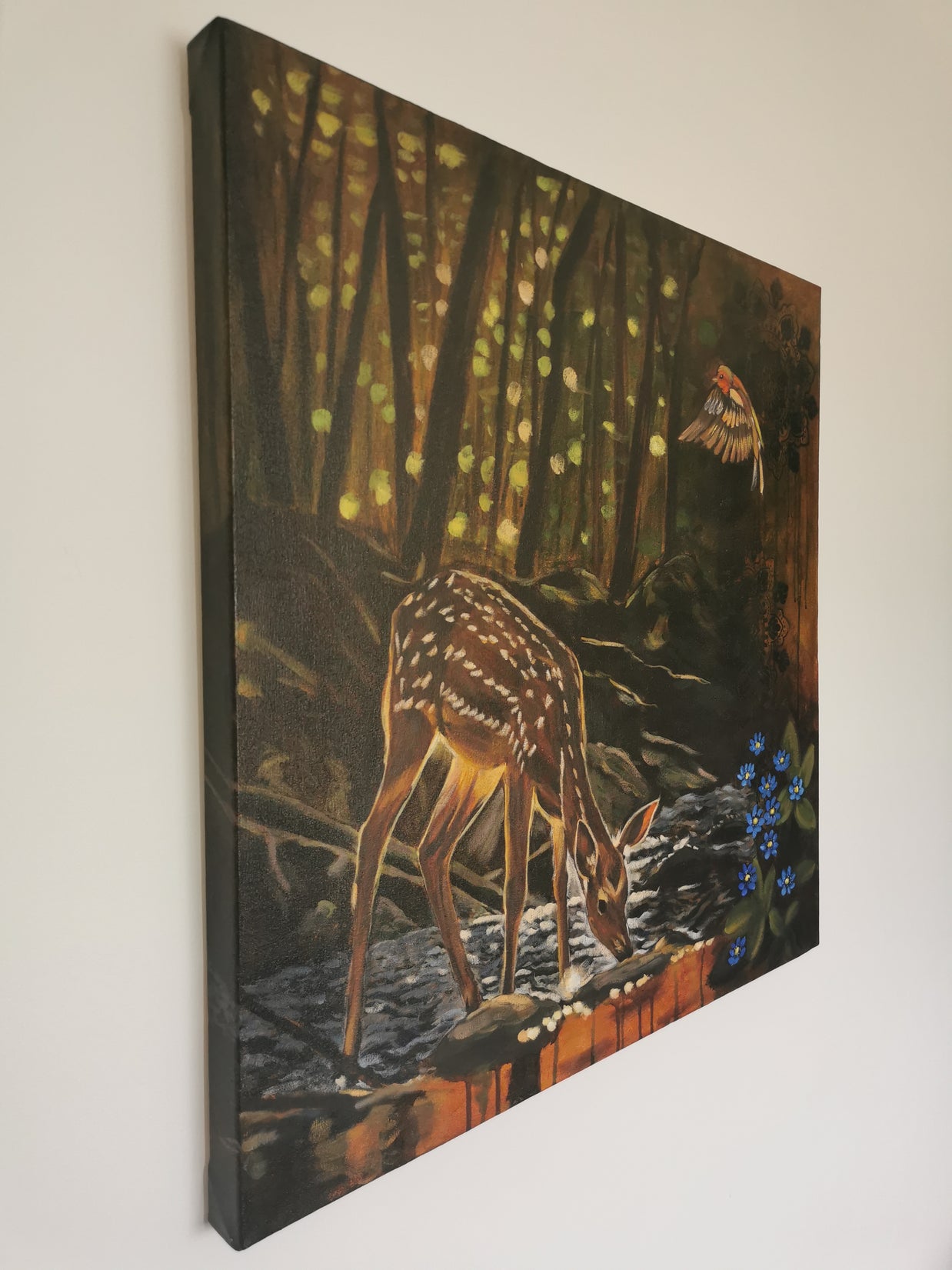 Stunning side view of a fawn in a forest scene with a bird